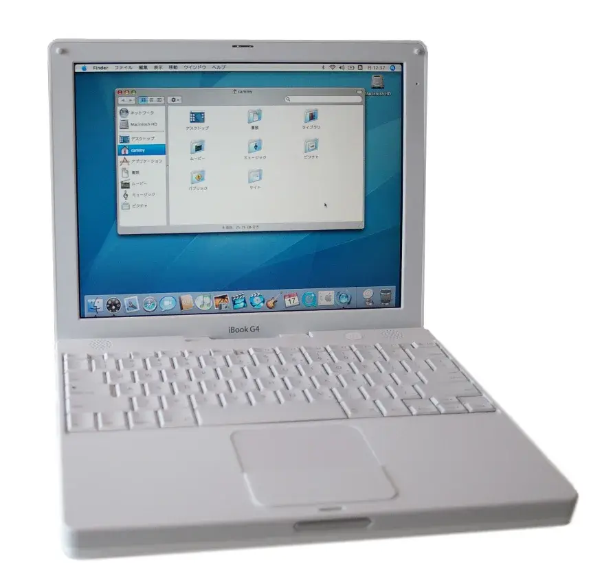 An open white iBook G4 with keyboard and trackball visible