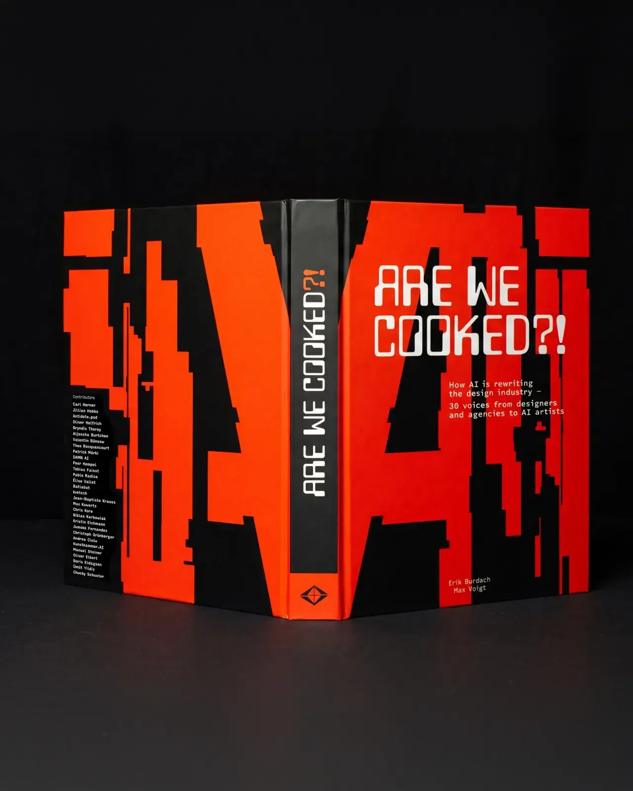 The red and black Are we cooked?! book opened against a dark background