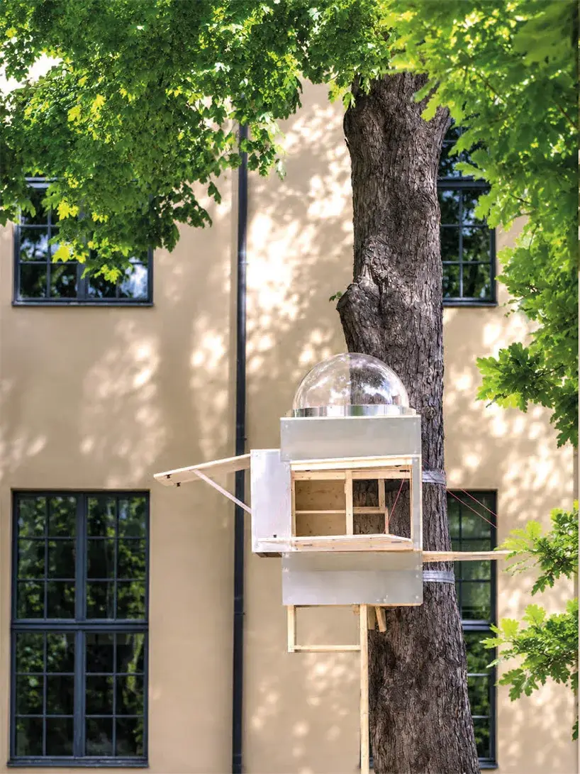 Very compact interior of Baumhaus Office with work table and timber walls