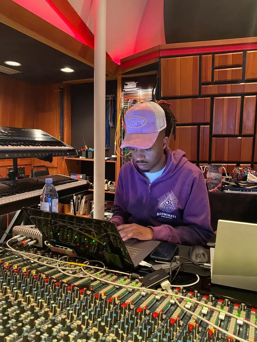 Metro Boomin working on a laptop in a recording studio