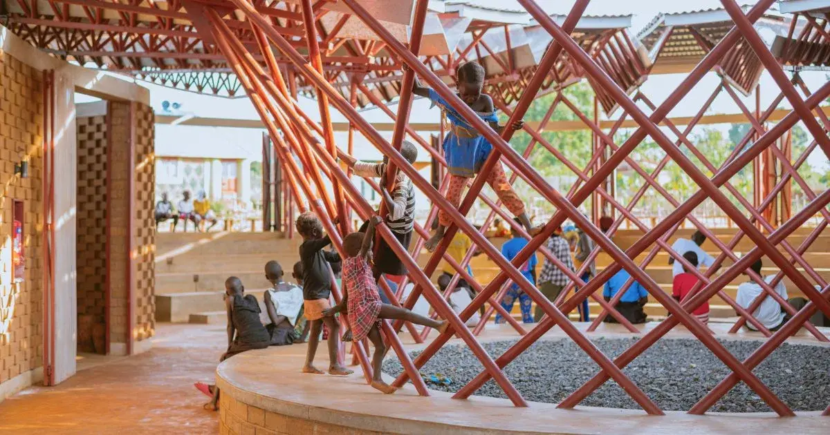 Bidi Bidi Performing Arts Centre in Uganda, with its broad metal roof above earth walls