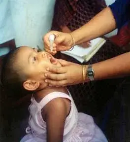Child receiving oral polio vaccine drops