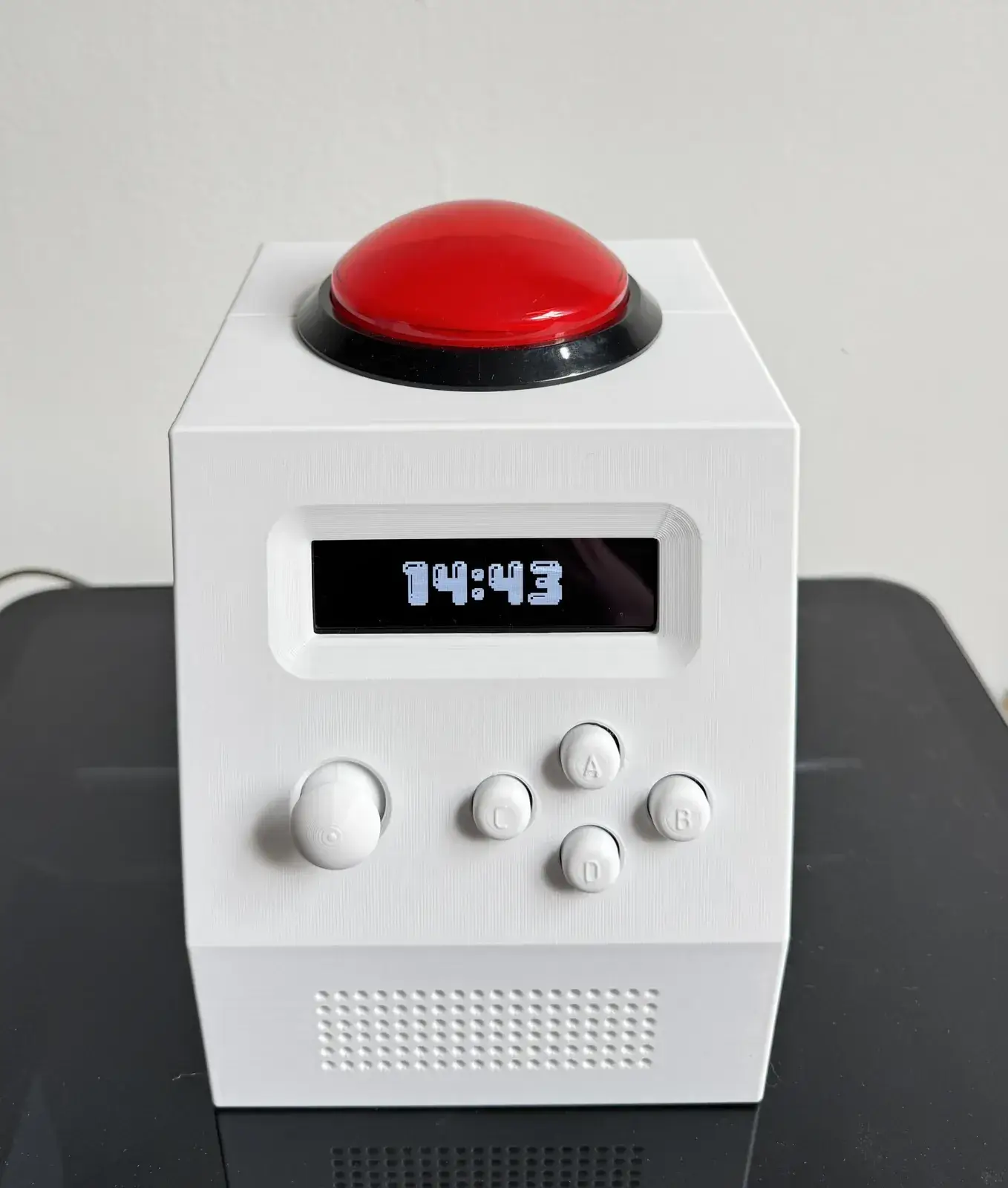 CinderClock 3D-printed desk alarm clock with raked OLED display and 100 mm arcade button on top