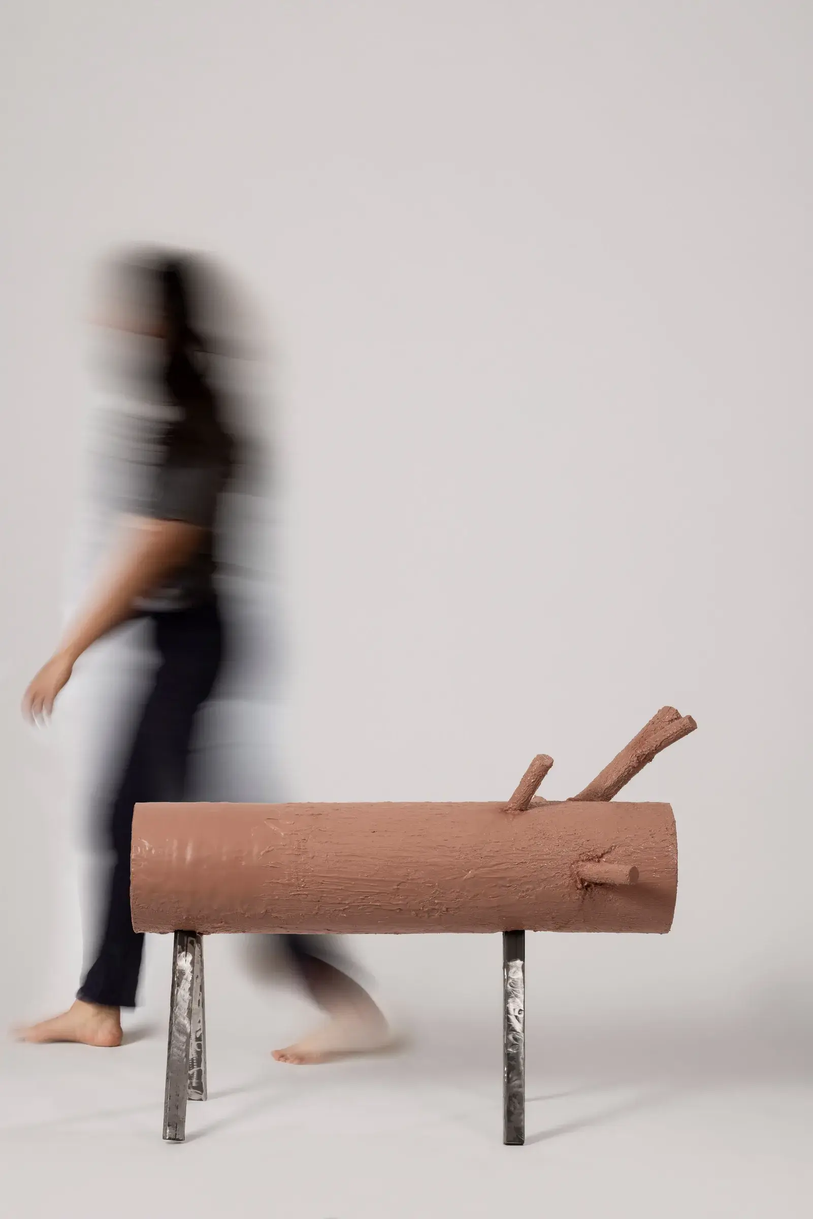 Log-shaped bench covered in textured synthetic rubber imitating skin