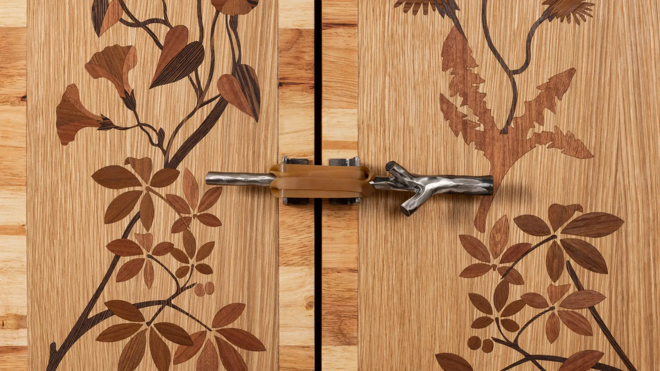 View of Shahar Livne's The Devil's Milk collection: dark furniture with organic surfaces mixing wood and rubber