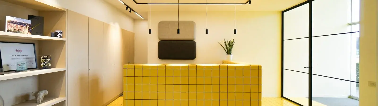 A set of white DTILE tiles covering a countertop and wall with continuous curves