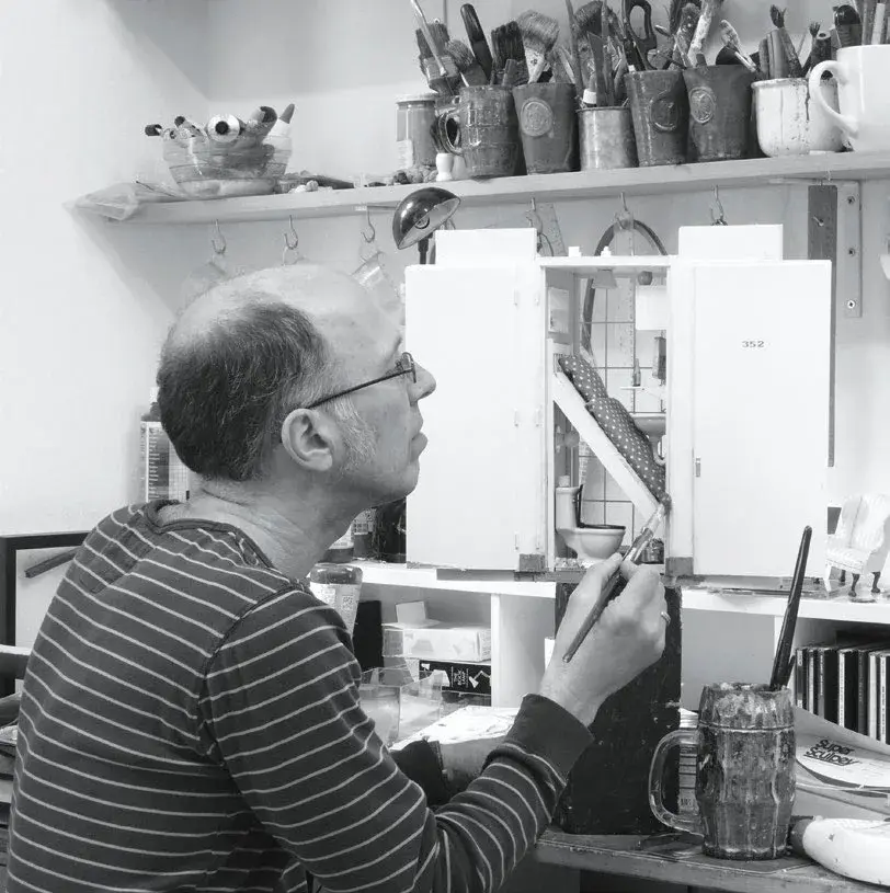 Frank Kunert with a photographic miniature set in his studio