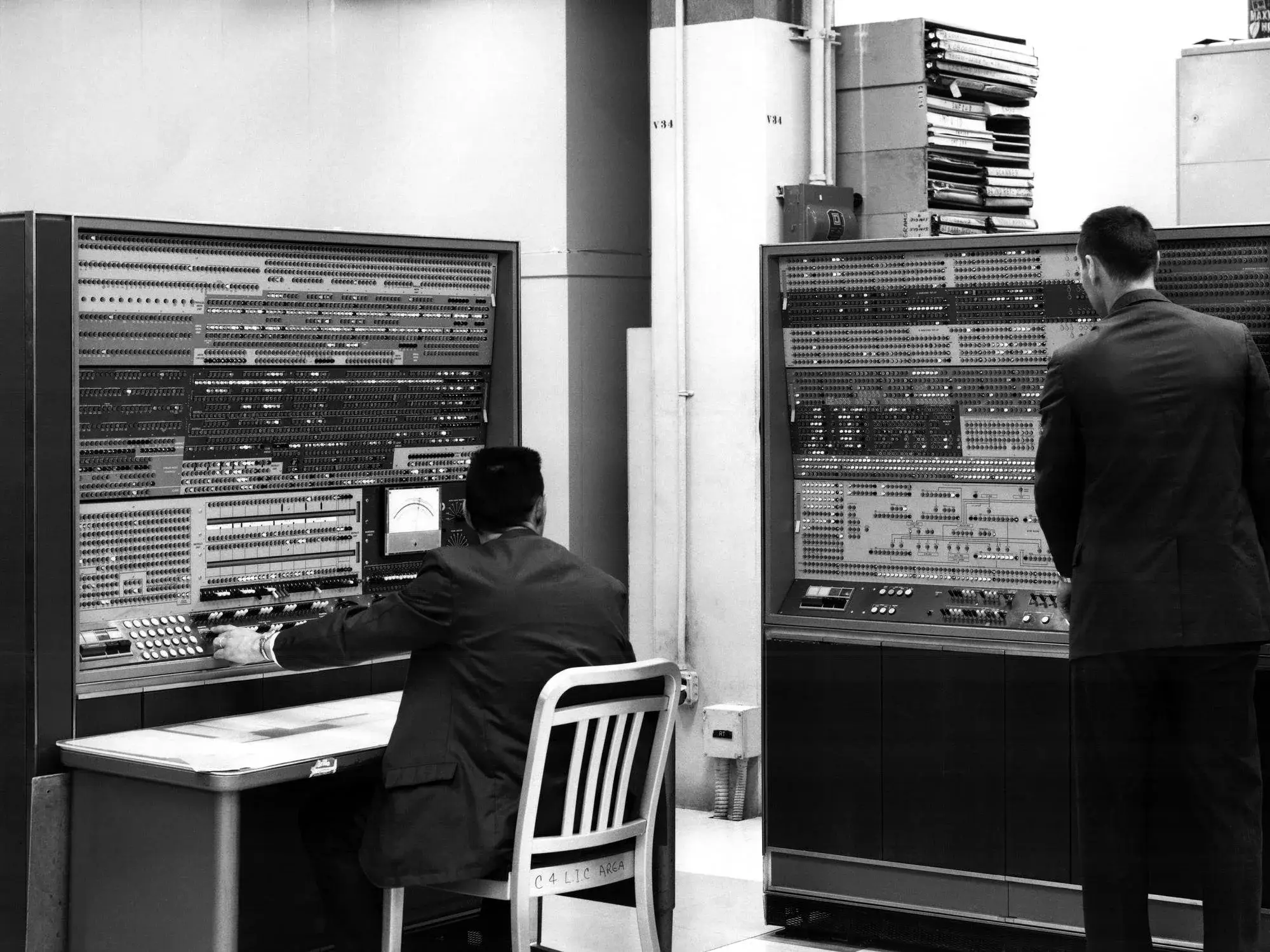 Two operators at the consoles of the Harvest computer during its installation at NSA headquarters