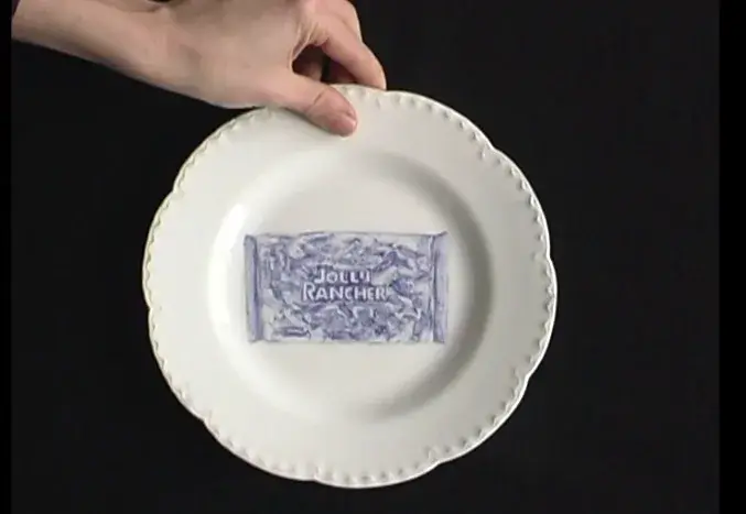 A plate from The Last Supper with a cobalt-blue depiction of a bag of Jolly Ranchers