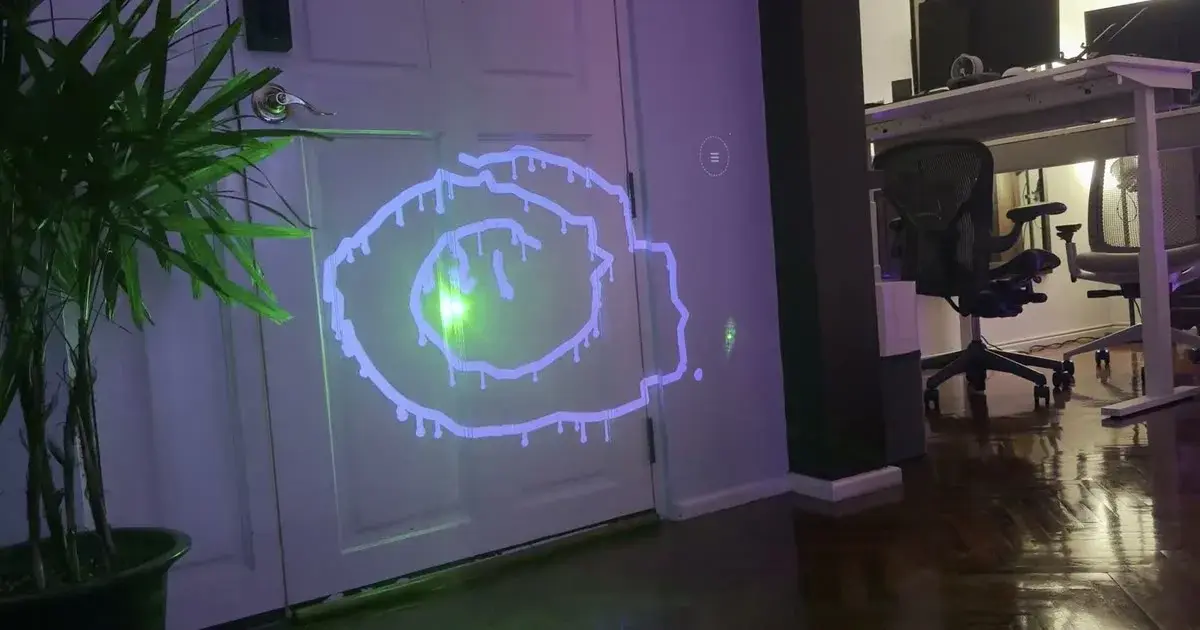 A wet-ink spiral projected onto a door, drawn with a green laser pointer