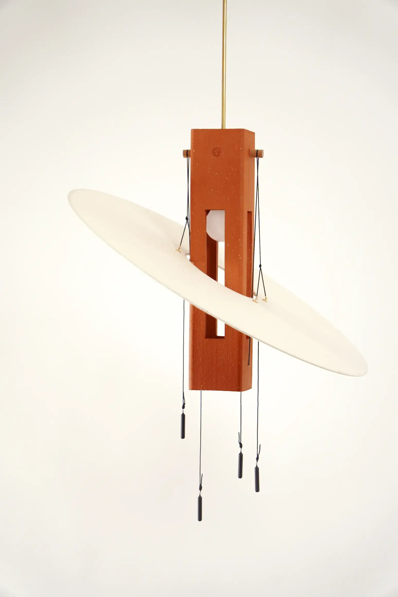 Nova Terracotta pendant with its washi paper veil tilted around the brick core