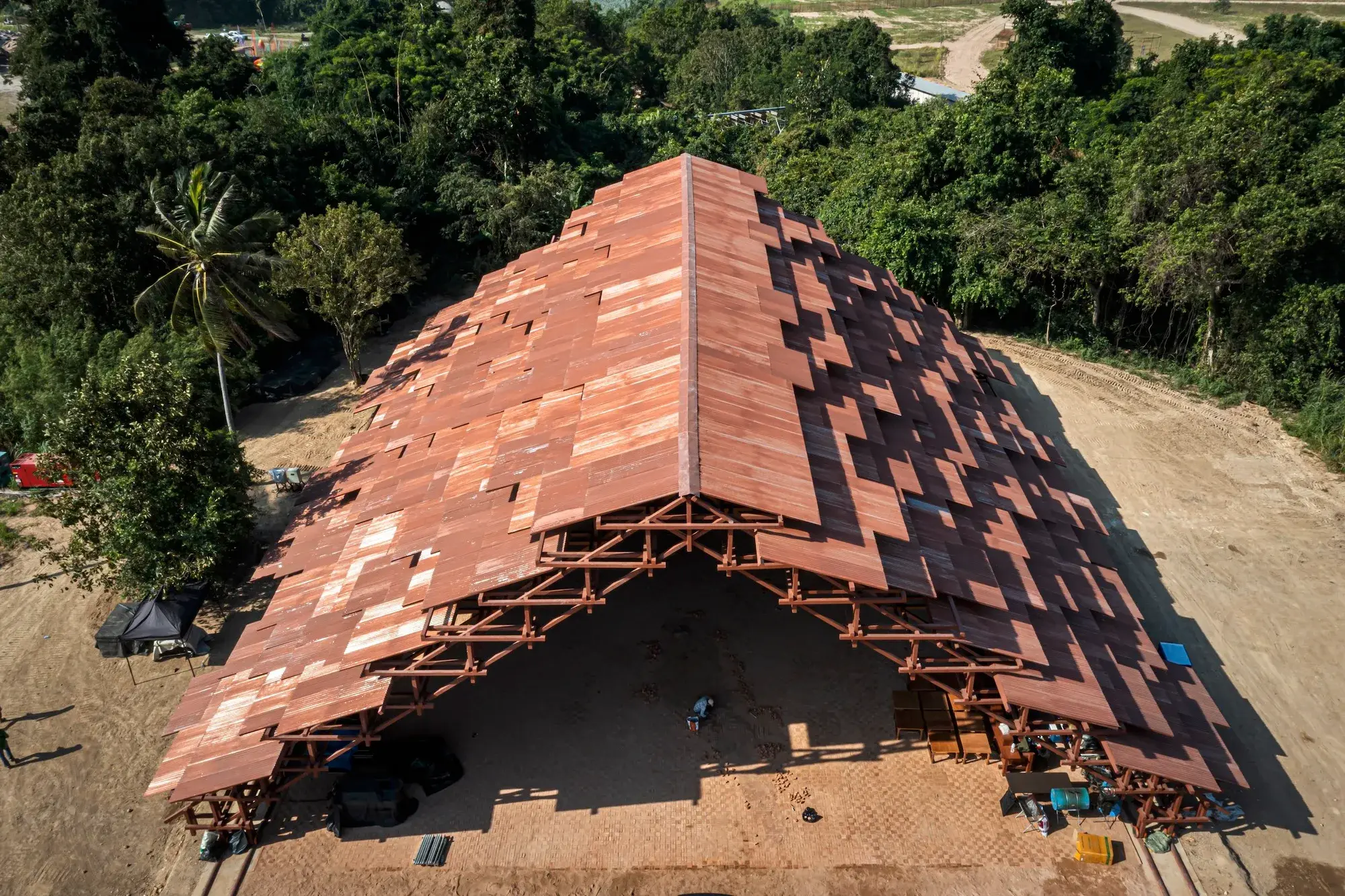 Neramit pavilion at Wonderfruit, a large open triangular roof made from steel and corrugated sheets