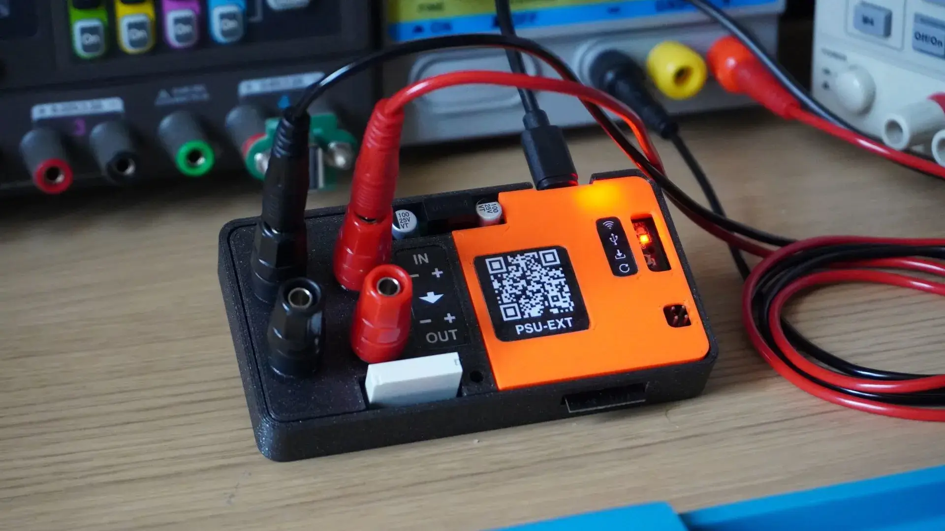 PSU-EXT prototype in a black enclosure with binding posts and USB-C connection
