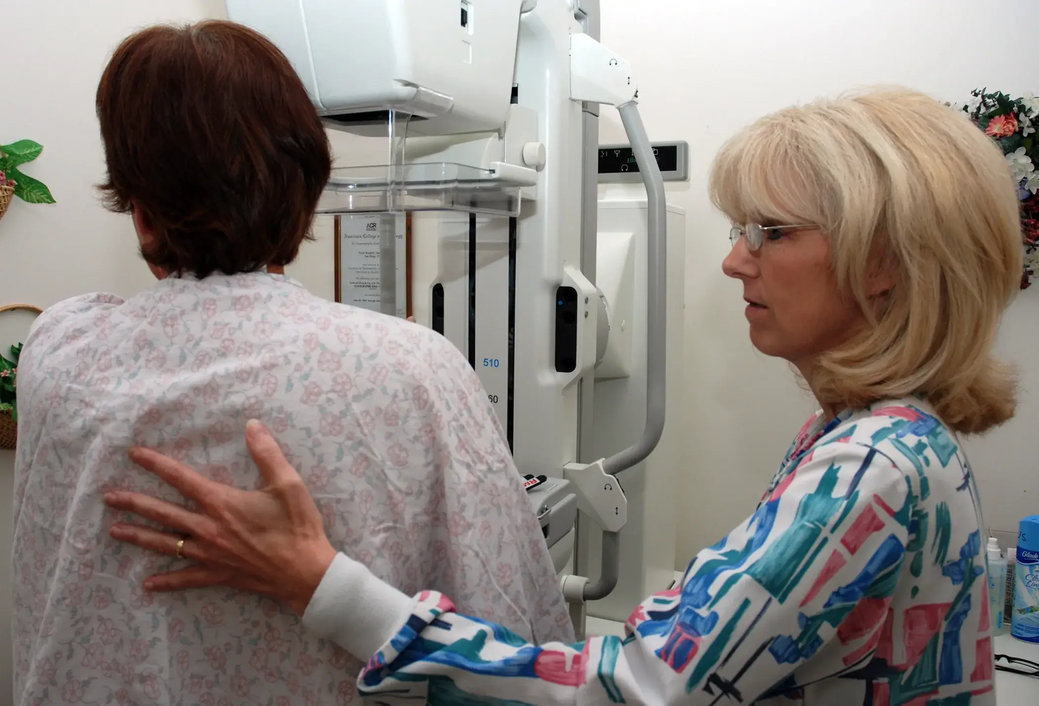 Technologiste en mammographie assistant une patiente lors d'un examen d'imagerie