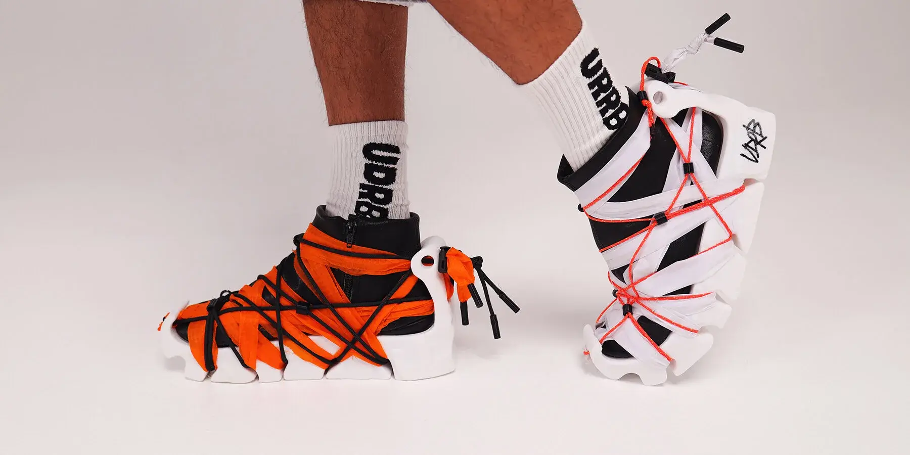UDRB sneaker with a white 3D-printed sole, black leather boot and bright green rope fastening